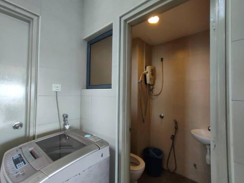 a bathroom with a sink and a toilet and a phone at Setiawalk Puchong 5 Bedrooms 14PAX 5 Mins TO LRT in Puchong