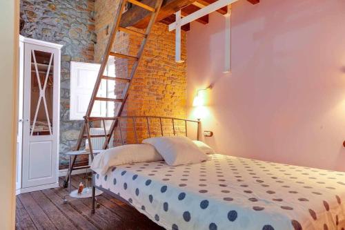 a bedroom with a ladder and a bed in a room at ático vistas centro 3min playaparking y wifi free in Laredo