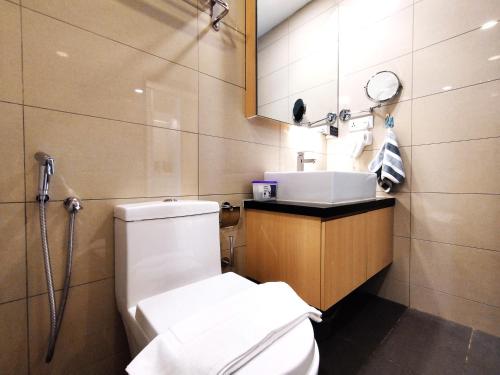 a bathroom with a toilet and a sink and a mirror at TopGenting BambooColdSuite4Pax @GrdIonDelmn in Genting Highlands