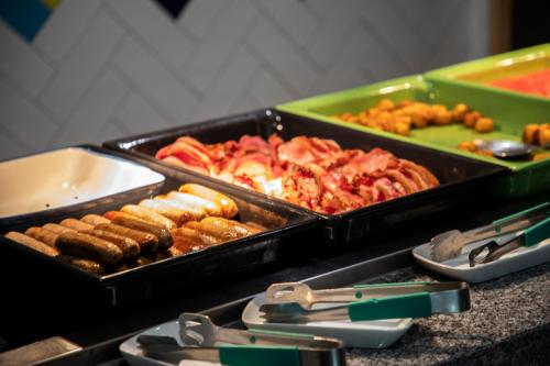 a table with trays of food on a table at Hampton By Hilton Stockton On Tees in Stockton-on-Tees