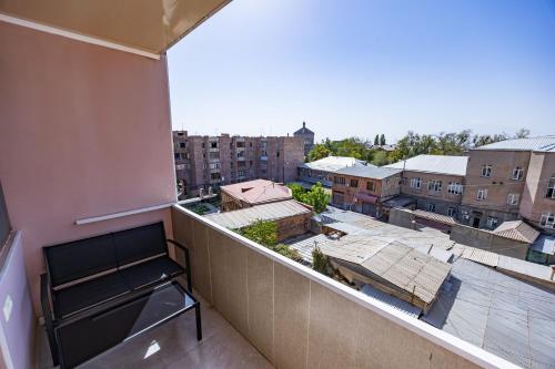 a balcony with a view of a city with buildings at Apartment in Ejmiactin in Vagharshapat