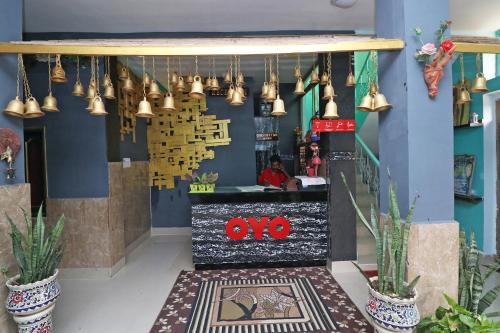 un restaurante con campanas colgando del techo en OYO Flagship Fun Friday Guesthouse en Bodh Gaya