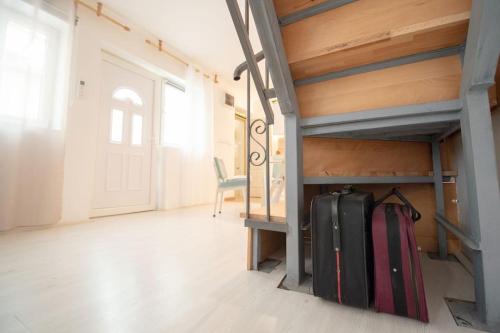 a suitcase sitting on the floor in a room at Central duplex apartment in Novi Sad