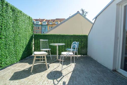 a patio with two chairs and a table and two chairs at Central duplex apartment in Novi Sad
