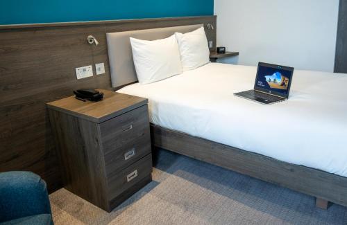 a hotel room with two beds and a laptop on a desk at Hampton By Hilton Stockton On Tees in Stockton-on-Tees