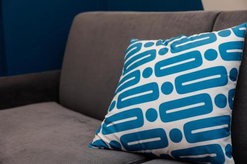 a blue and white pillow sitting on a couch at Valaoritou 3 Luxury Rooms in Thessaloniki