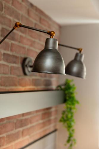two metal lights hanging on a brick wall at Valaoritou 3 Luxury Rooms in Thessaloniki