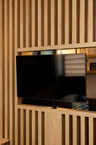 a flat screen tv on a wooden wall at Valaoritou 3 Luxury Rooms in Thessaloniki