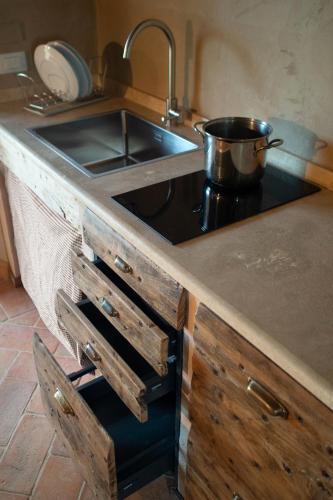a kitchen with a sink and a pot on a stove at Agriturismo Borgo Malva' in San Venanzo