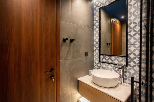 a bathroom with a sink and a mirror at Valaoritou 3 Luxury Rooms in Thessaloniki