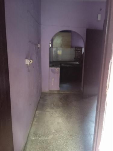 ein dunkles Zimmer mit einem Flur und einem Zimmer mit einem Tisch in der Unterkunft City stay in Gurgaon