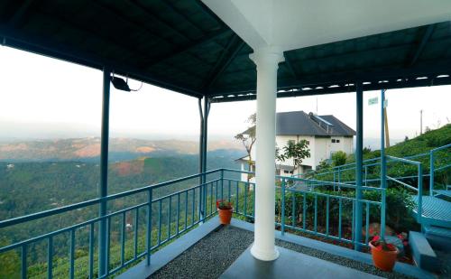 a balcony of a house with a view of the mountains at 10 Degrees North By Avni Holidays in Idukki