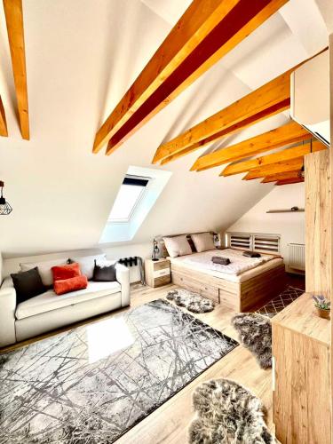 a living room with a couch and a bed at Barkland Apartman in Tarcal