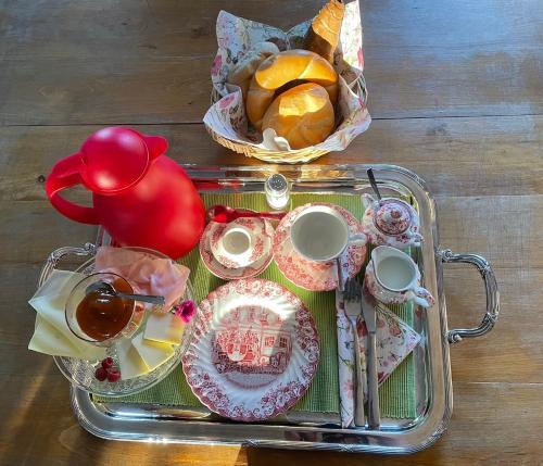 a tea tray with a tea pot and a tray of food at Gästehaus Taschler Hof 