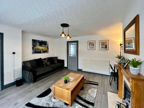 a living room with a couch and a table at Havenwood House - Great for Contractors or Family Holidays in Nottingham