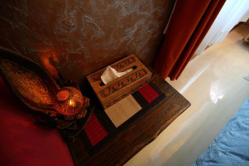 a box of tissues on a table next to a bed at Sweet Heart B&B in Jian