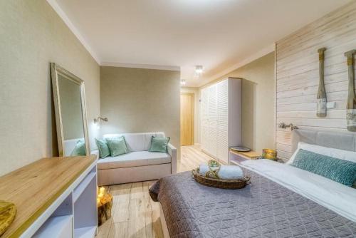 a living room with a bed and a couch at Natura Mierzei 30 - pokoje przy plaży in Krynica Morska