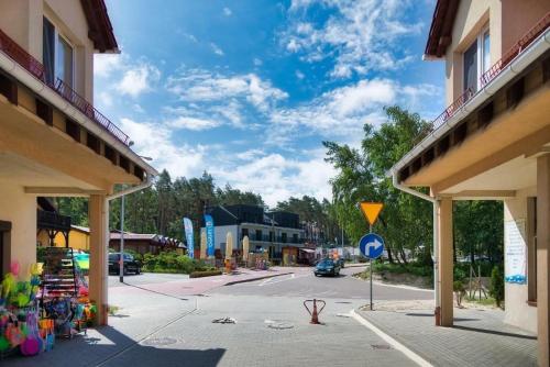 a street in a town with buildings and a road at Natura Mierzei 30 - pokoje przy plaży in Krynica Morska