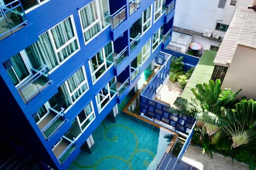 an aerial view of a blue building with a swimming pool at Bhukitta Boutique Hotel Phuket Town in Phuket
