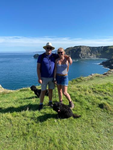a man and woman standing on a hill with two dogs at Bedport Loft in Burrington