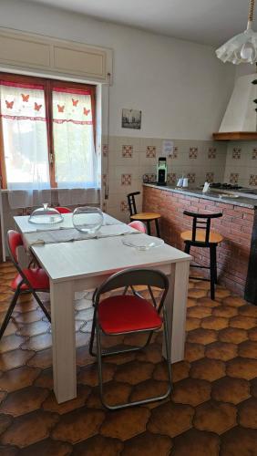 a kitchen with a white table and chairs in a room at Adri's House in Monterotondo