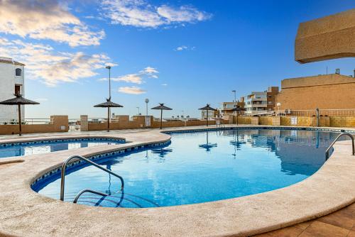 a large swimming pool with a blue sky in the background at Myflats Premium Arenales Hills in Arenales del Sol