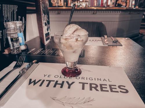 a drink sitting on a table with a napkin at Ye Olde Original Withy Trees in Bamber Bridge