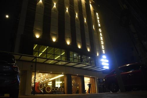 a building with a sign on it at night at HOTEL EDEN GARDEN in Āsansol