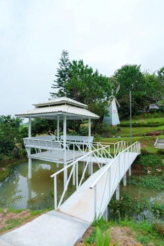 a bridge over a pond with a gazebo at เขาค้อออฟเลิฟ in Khao Kho
