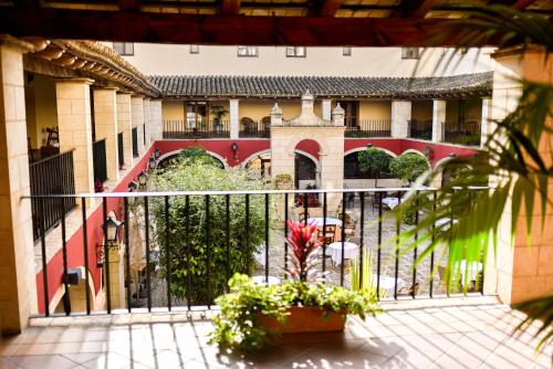 a courtyard of a building with a fence and plants at ALEGRIA Bodega Real in El Puerto de Santa María