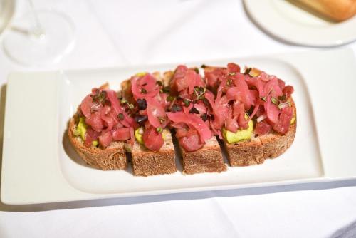 a sandwich on a white plate on a table at ALEGRIA Bodega Real in El Puerto de Santa María