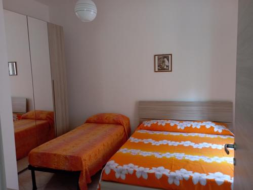 a bedroom with a bed and a bench in it at Sardinia ovest in Oristano