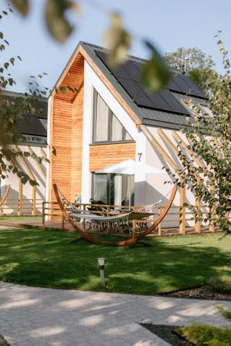 a house with a large boat in the yard at Vacanza Park in Łeba