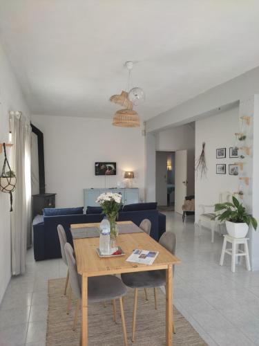 a living room with a table and a blue couch at Nature et al House - Casa para uso exclusivo e jardim - Little farm in Batalha