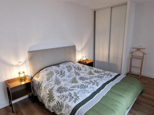 a bedroom with a bed and two night stands at La Petite Marine a 150m de la plage in Brétignolles-sur-Mer