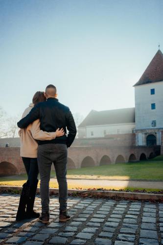 a man and a woman standing in front of a building at R31 Residence in Sárvár
