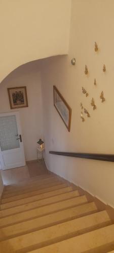 a room with stairs and butterflies on the wall at I Cappuccini B&B in Sorso