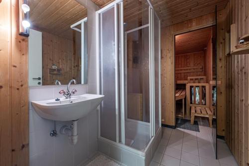 a bathroom with a sink and a glass shower at Gipfelblick Residenz #1 in Kitzbühel