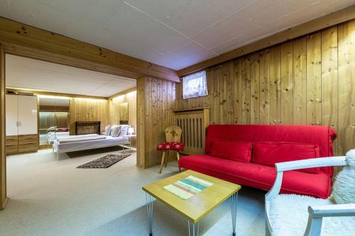 a living room with a red couch and a table at Gipfelblick Residenz #1 in Kitzbühel