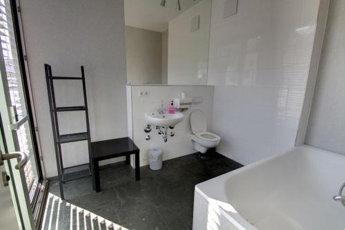 a small bathroom with a toilet and a sink at Heart of Gold Hostel Berlin in Berlin