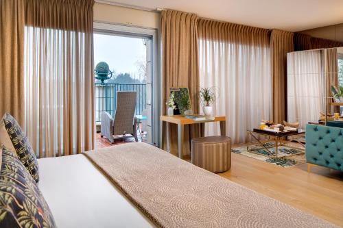 a hotel room with a bed and a large window at La Côte Saint Jacques in Joigny