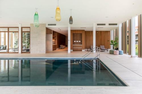 an indoor pool in a house with a living room at Van der Valk Hotel Hengelo in Hengelo