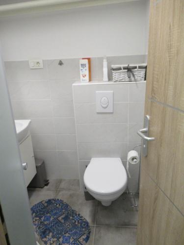 a small bathroom with a toilet and a sink at Relax Beach Apartment in Split