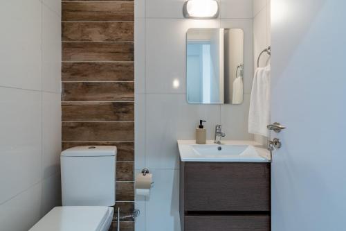 a bathroom with a toilet and a sink at Latte's Prime 1-Bedroom Apartment in Larnaca in Larnaca