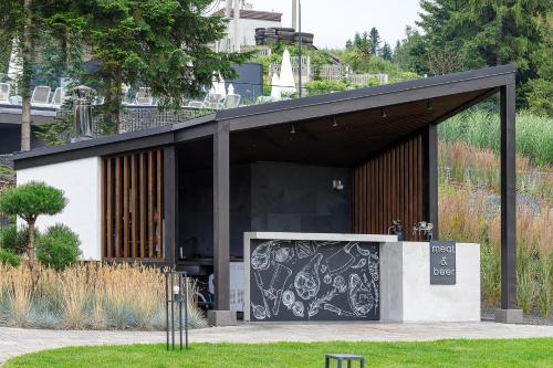 a black and white building with a large door at Crona SPA Karpaty in Skhidnitsa