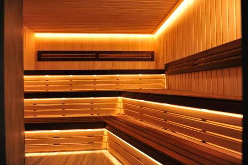 an empty sauna with wooden benches and lights at Crona SPA Karpaty in Skhidnitsa