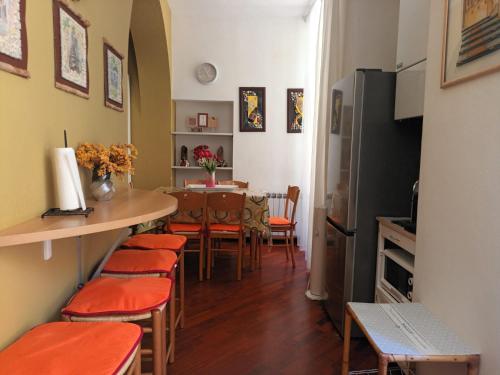 a kitchen and dining room with a table and chairs at Larysa in Sanremo