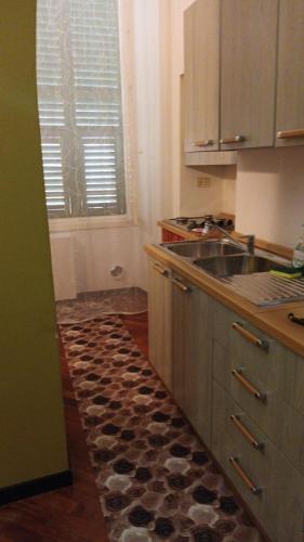 a kitchen with a sink and a counter top at Larysa in Sanremo
