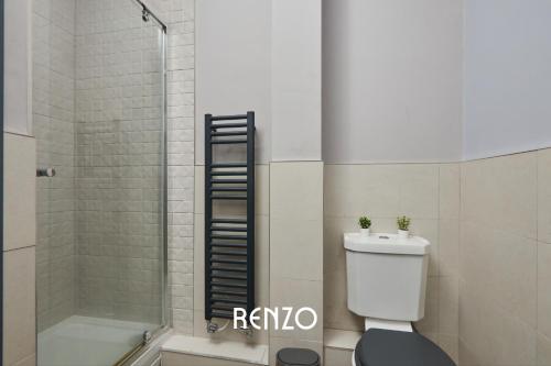 a bathroom with a shower and a toilet and a sink at Cosy 1-bed Apartment in Derby by Renzo, Free Wi-Fi, Sofa Bed, Sleeps 3! in Derby
