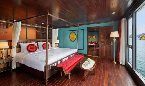 a bedroom with a bed with a red bench in it at Indochine Premium Halong Bay in Ha Long